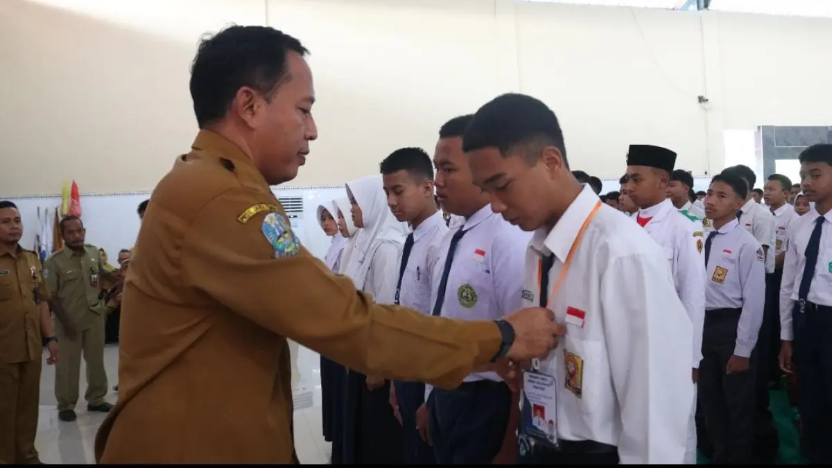 BERGABUNG: Kepala SMKN 1 Dlanggu, Johan Bahrudin menyematkan tanda peserta kepada siswa baru saat Pembukaan MPLS, Senin (13/7). (Indah jprm)