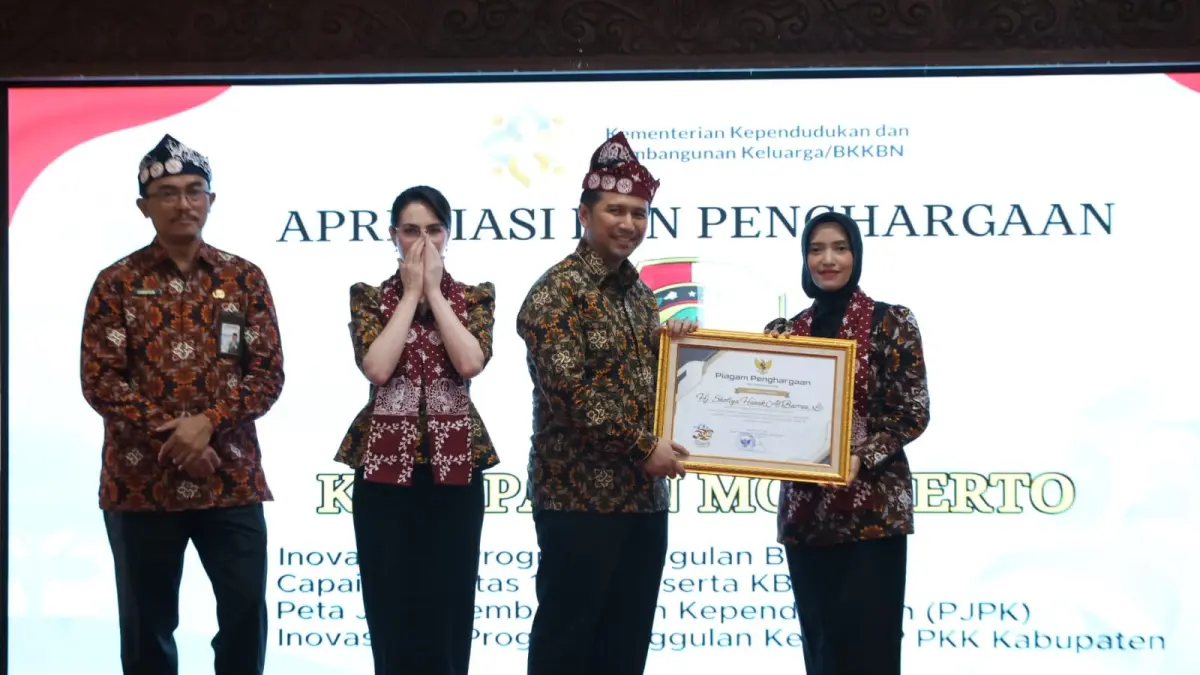 MEMBANGGAKAN: Istri Wabup dr Amelia Fitri mewakili Ketua TP PKK Kabupaten Mojokerto menerima penghargaan dari Wakil Gubernur Jatim Emil Elestianto Dardak di Peringatan Harganas ke-33 tingkat Provinsi Jatim 2026 di Pendopo Agung, Kabupaten Malang, Rabu (29/7).