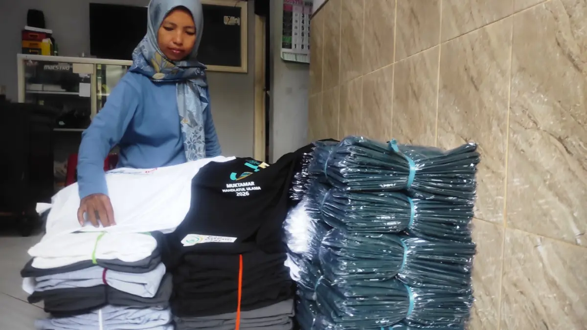 RAUP BERKAH: Pelaku usaha sablon mengerjakan desain kaus yang akan dijual selama Muktamar ke-35 NU di PPBU Tambakberas, Jombang, 27-31 Agustus mendatang. (Farisma JPRM)