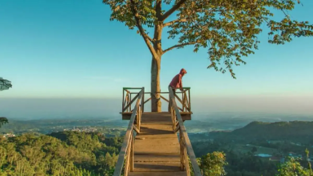 Pengunjung menikmati panorama perbukitan dan hamparan alam Mojokerto dari spot ketinggian di Pacet Hill Outdoor Park.