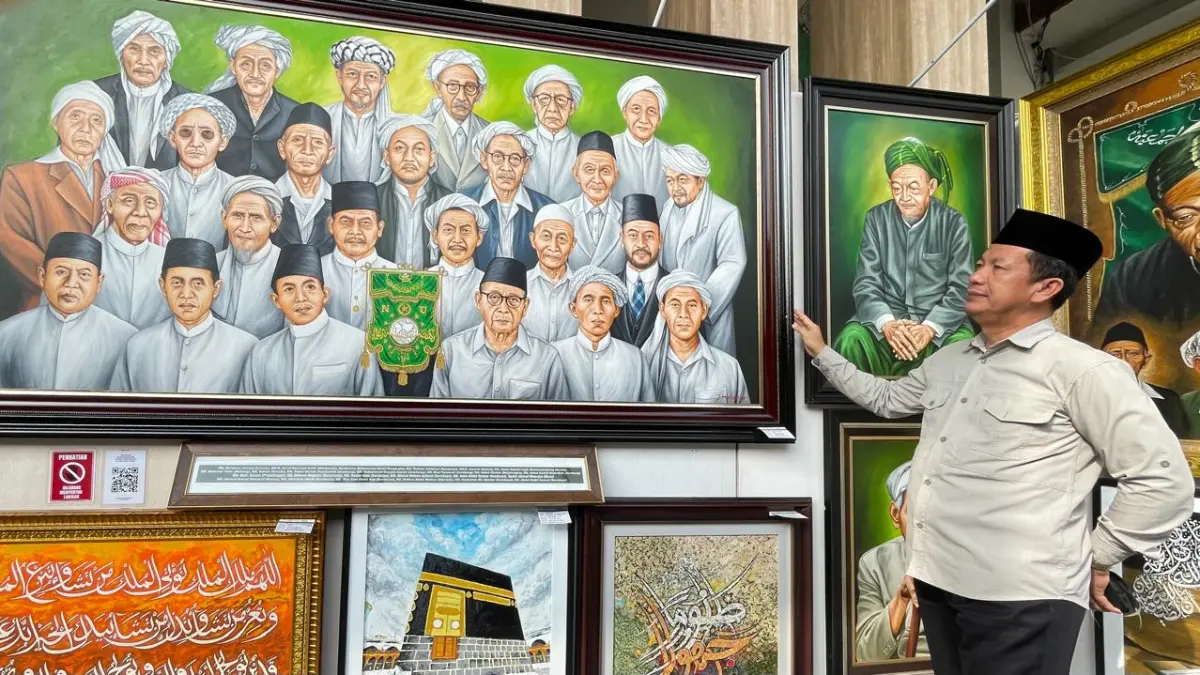 KARYA KADER NU: Pengunjung pameran lukisan NU dan kaligrafi mengamati lukisan bertema 25 muassis NU, di Ribath Al-Wahabiyyah PPBU Tambakberas, Jombang, Rabu (26/8).&nbsp; (Chariris/JPRM)