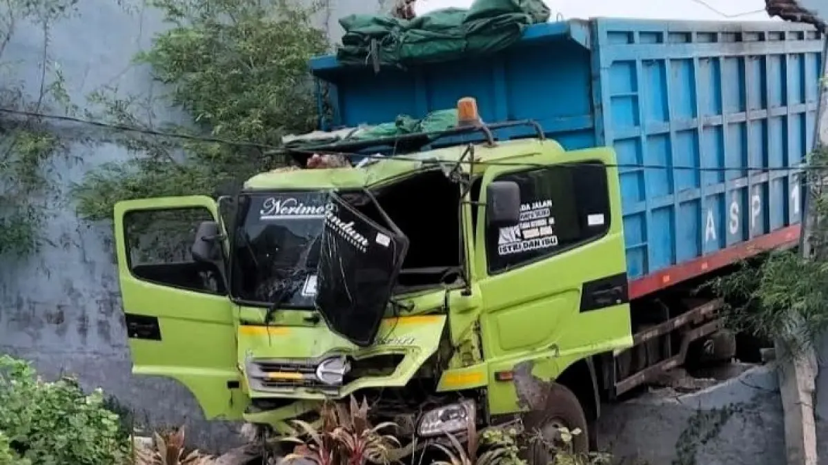 DINDING JEBOL: Tembok pembatas pabrik PT Kasmaji Inti Utama dan makam umum Desa Perning jebol usai dihantam dump truck, Senin (14/9) petang.