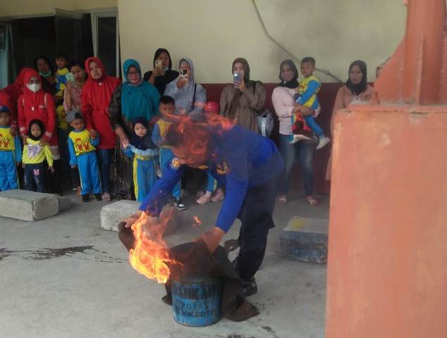 EDUKASI: Petugas UPTD Damkar Kota Mojokerto mengajari siswa sekolah dasar cara memadamkan api, kemarin. (Yulianto Adi Nugroho/Jawaposradarmojokerto.id)