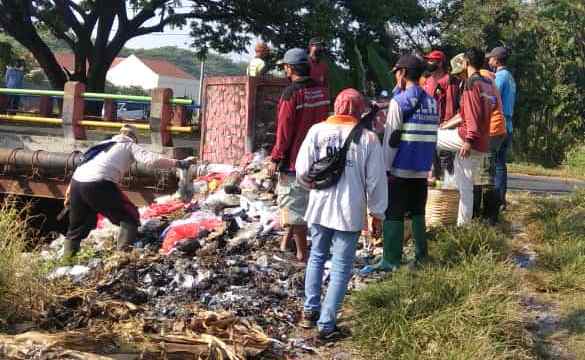PEMBERSIHAN: Petugas DLH Kota Mojokerto mengangkut sampah liar yang dibuang di tepi Jalan Raya Meri, Kecamatan Kranggan, kemarin.