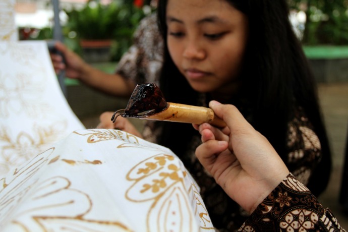 KREATIF: Salah satu siswa SMA Negeri 1 Sooko menggambar pola batik yang akan dijadikan seragam.