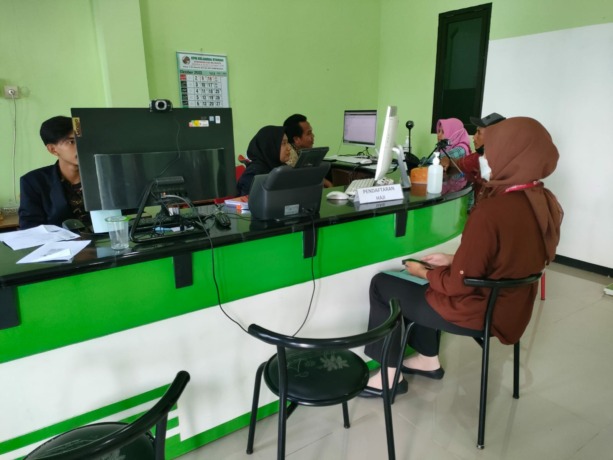 TETAP BERLAKU: Salah satu calon jamaah menyetorkan berkas persyaratan ibadah umrah untuk dicek oleh petugas di kantor Kemenag Kabupaten, kemarin. Tahun ini, calon jamaah diimbau masih wajib melakukan vaksinasi meningitis seperti semula.