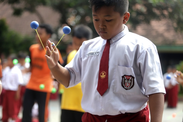 KETANGKASAN: Peserta didik SDN Balongsari 5 dan SDN Balongsari 6 saat berlatih memainkan lato-lato saat jam istirahat, Kamis (12/1). (Sofan Kurniawan/JPRM)