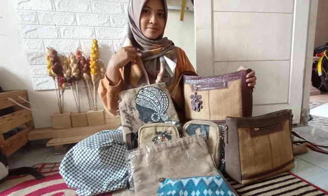 ANEKA RAGAM: Endang menunjukkan koleksi tas berbahan kain goni buatannya yang berhasil menembus pasar antardaerah. (Indah Oceananda/Jawa Pos Radar Mojokerto)