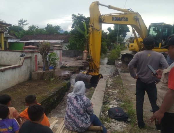 DIBONGKAR: Petugas DPUPR Kabupaten Mojokerto membongkar jembatan permanen yang menjadi pemicu banjir di Desa Wonorejo, Kecamatan Trowulan. (Rizal Amrulloh/JPRM)