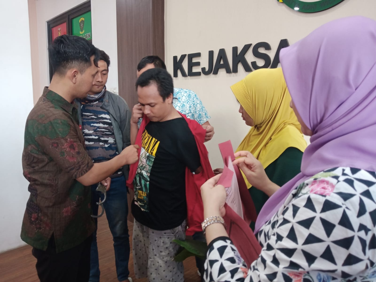 DIBEBASKAN: Kedua terdakwa saat dibebaskan dan bertemu keluarganya usai mendapat RJ di kantor Kejari Gresik.
