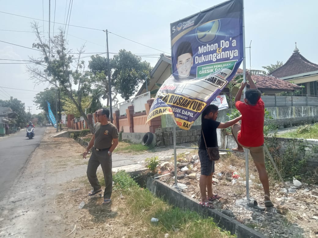PEMBERSIHAN: Sejumlah parpol melakukan pencopotan APK karena belum waktunya kampanye.