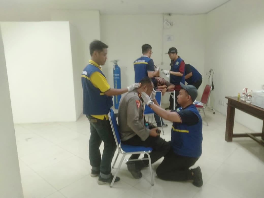 Foto : Istimewa/Radar Gresik LUKA : Kabag Ops Polres Gresik Kompol Andria Diana Putra saat mendapatkan perawatan medis oleh tim kesehatan.