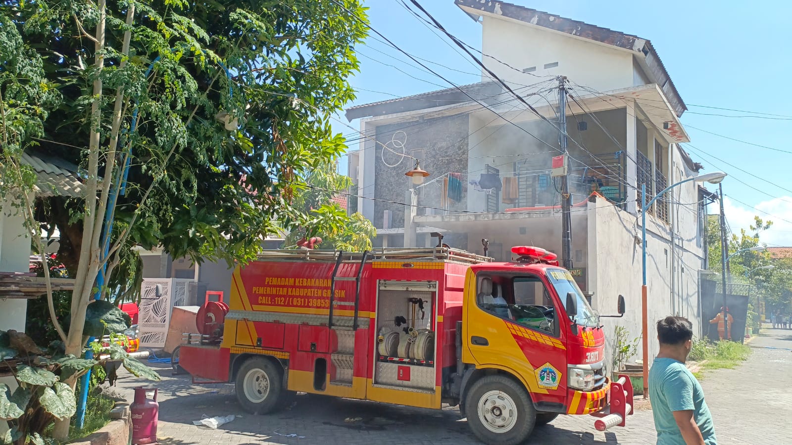 Gerak Cepat : Petugas Pemadam Kebakaran Pemkab Gresik bergerak cepat memadamkan api yang membakar dapur Papa Cookies.