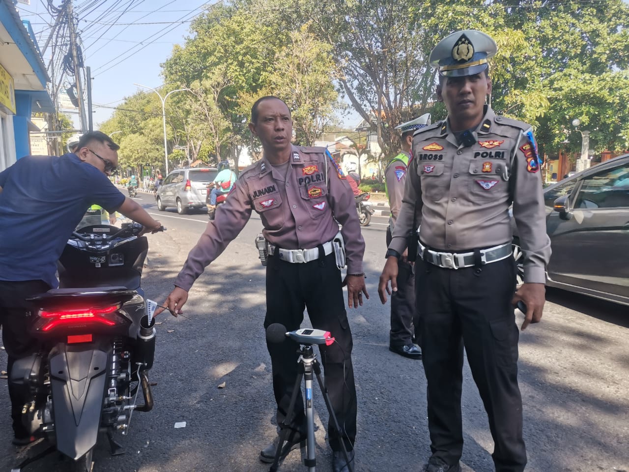 PENGECEKAN: Kanit Turjawali Satlantas Polres Gresik Ipda Bross Tito Dharmawan melakukan pengecekan kebisingan knalpot brong menggunakan perangkat sound level meter.