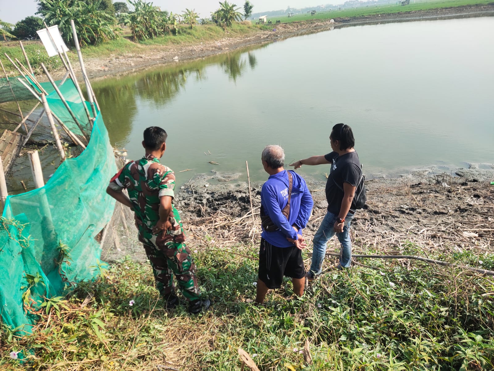 OLAH TKP: Anggota Polsek Cerme saat melakukan evakuasi dan olah TKP di tepi Waduk Desa Banjarsari, Kecamatan Cerme, Gresik.