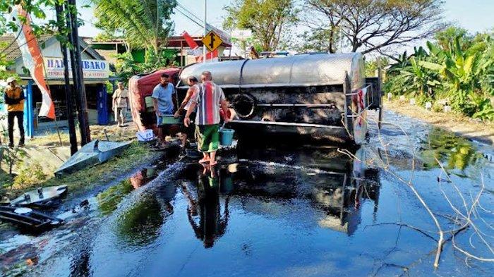 MINYAK TUMPAH: Warga berebut minyak goreng tumpah di jalan Canggu Mojokerto.