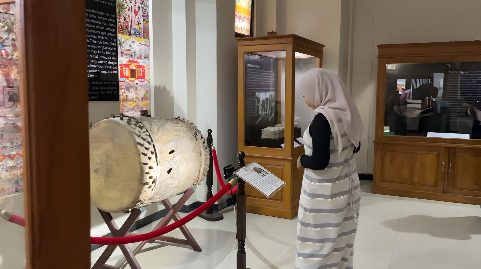 KOLEKSI: Salah satu mahasiswa bernama Dwi sedang melihat berbagai koleksi di Museum Sunan Giri.