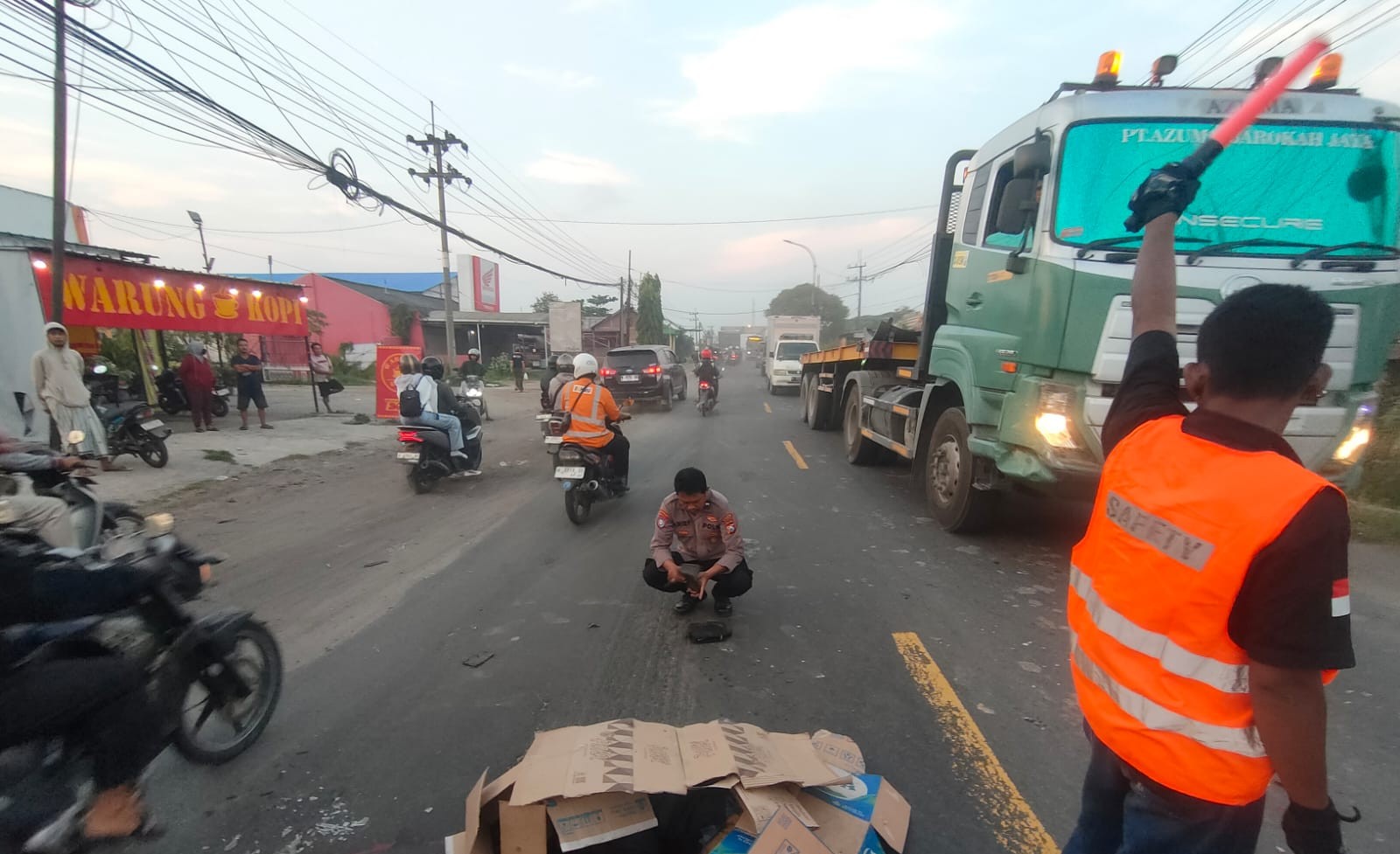 OLAH TKP : Anggota Polsek Manyar saat melakukan evakuasi korban kecelakaandi Jalan Raya Sembayat, tepatnya di pertigaan pintu masuk Desa Gumeno, Kecamatan Manyar, Gresik.
