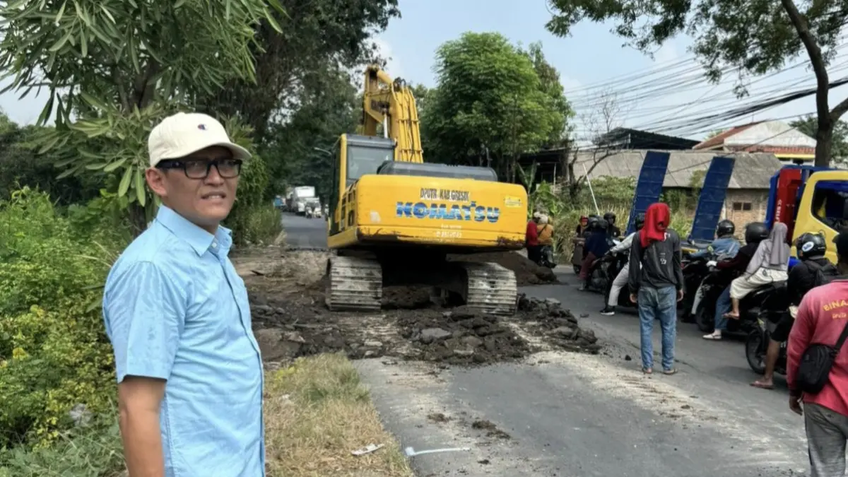 SIDAK: Wakil Ketua III DPRD Gresik Abdullah Hamdi saat meninjau langsung proses perbaikan jalan rusak di ruas Boboh-Hendrosari yang sempat memicu kecelakaan. (Fajar/Radar Gresik) 