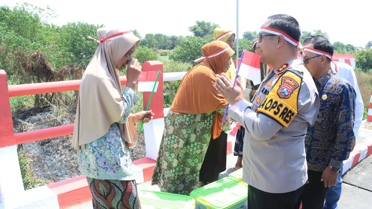 JEMBATAN MERAH PUTIH : Kapolres Gresik AKBP Ramadhan Nasution saat meninjau langsung jembatan merah putih yang berada di Dusun Munggugebang, Desa Munggugebang, Kecamatan Benjeng, Gresik. (Foto : Ist/Radar Gresik) 