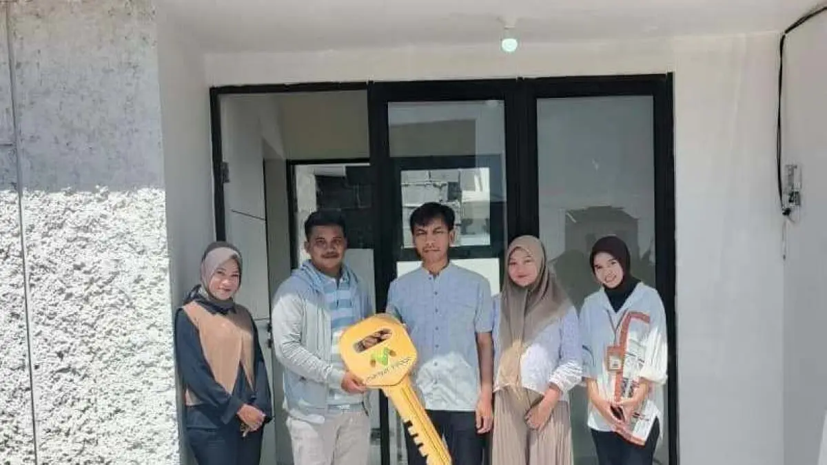 Lega : Tubagus Muhammad Hidayatullah bersama istrinya jadi satu dari puluhan konsumen yang menerima kunci perdana dari tim marketing Keluarga Sejahtera Grup. (IST/ RADAR GRESIK)
