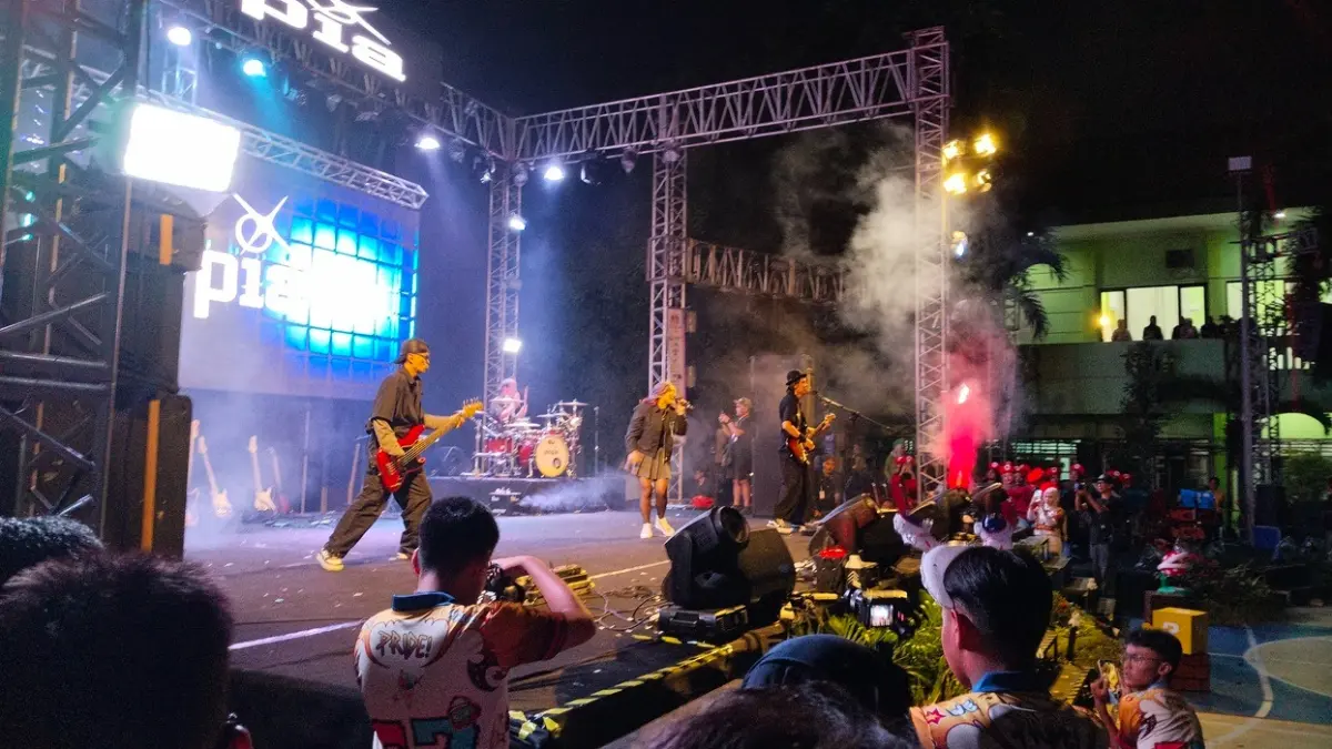 MEMBARA: Penampilan Guest Star Utopia Band membakar semangat ratusan siswa dan tamu undangan dalam malam puncak SPEKTAVIA 2026 di panggung utama SMAN 1 Gresik. (Foto : Riri/Radar Grsik) 