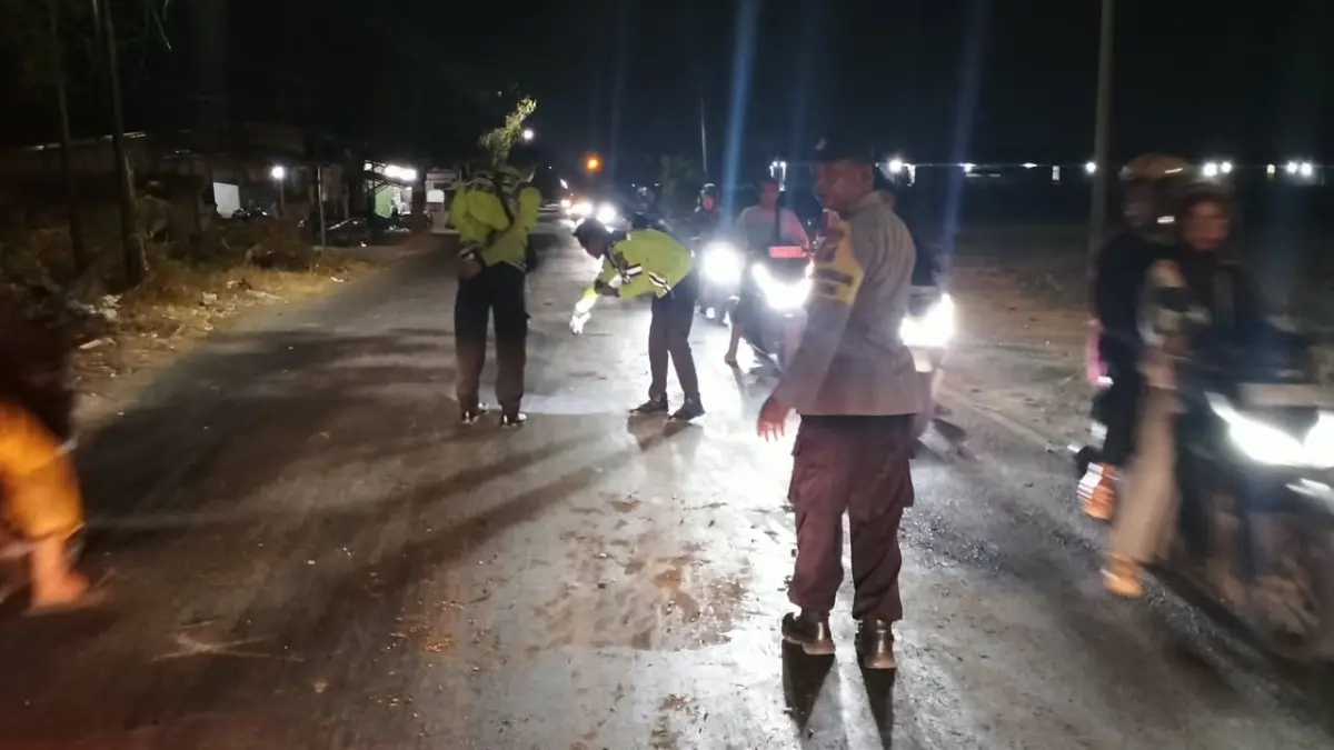 OLAH TKP : Anggota Polisi saat melakukan olah TKP Kecelakaan di Jalan Raya Desa Metatu, Kecamatan Benjeng, Gresik. (Foto : Ist/Radar Gresik) 