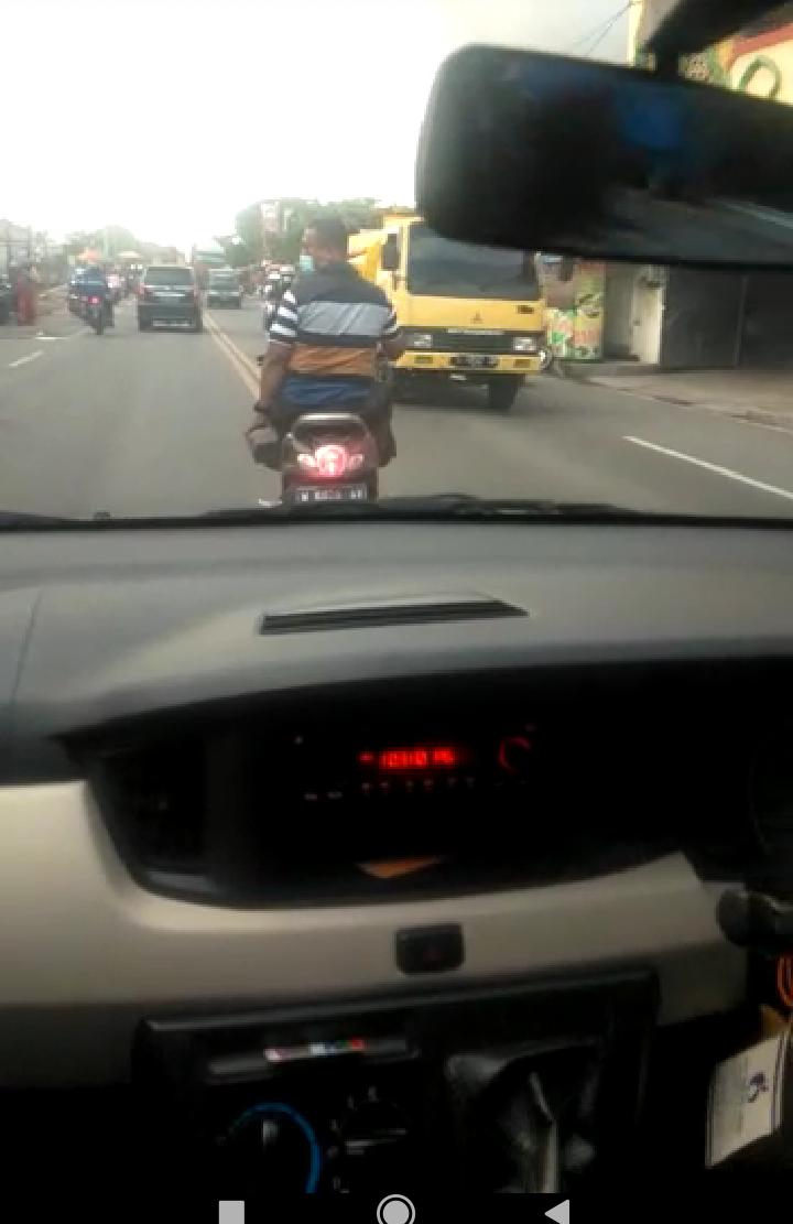 Foto : Istimeea/Radar Gresik BAWA PAVING : Pelaku terekam camera saat membawa paving untuk menakuti pengendara mobil saat di Jalan Raya Manyar.