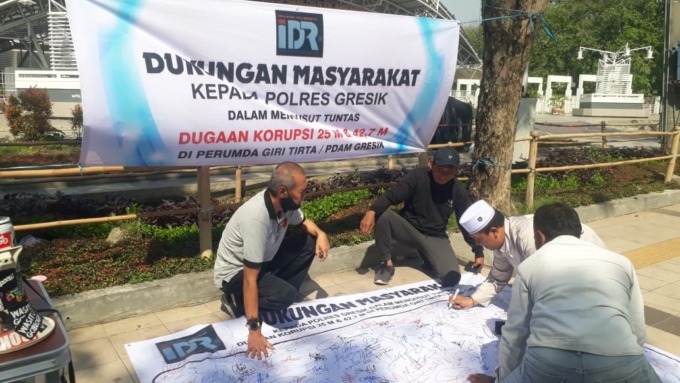 DUKUNGAN  UNTUK POLRES: Warga memberikan dukungan tanda tangan terkait kasus dugaan korupsi di PDAM yang ditangani Satreskrim Polres Gresik. (Ist./Radar Gresik)