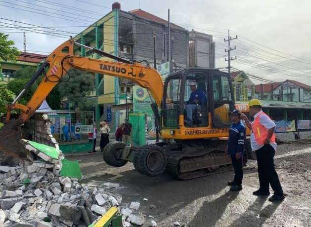 PEMBONGKARAN: Petugas dari Pemkab Gresik saat merobohkan ratusan bangunan di sepanjang Jalan Raya Manyar. (ISTIMEWA/RADAR GRESIK)