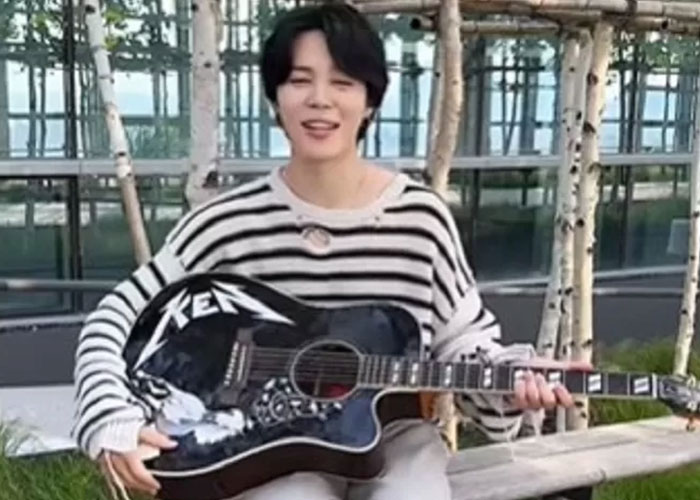 Jimin BTS memegang gitar hadiah dari Ryan Gosling, pemeran Ken di film Barbie.