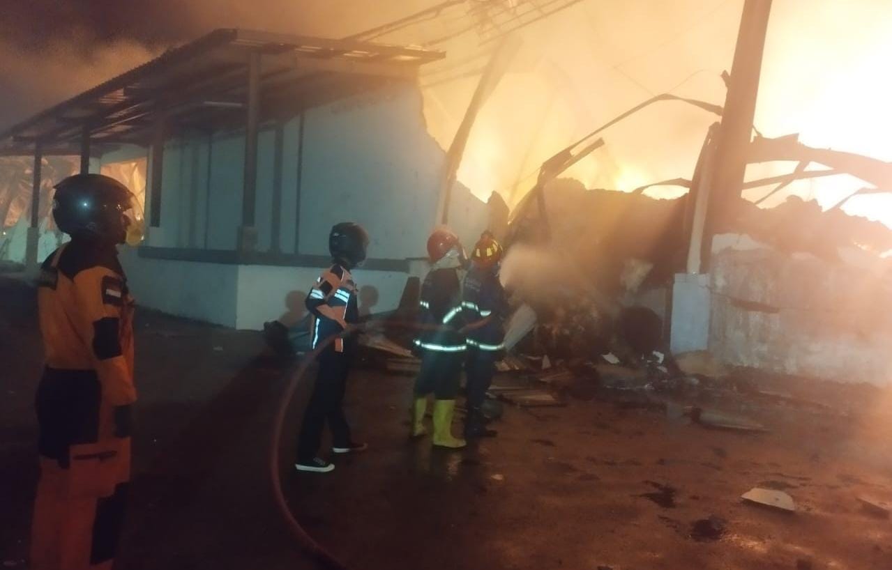 Petugas damkar berupaya keras padamkan api di gudang penyimpanan kapas PT Tantra, Jalan Solo-Sragen KM 14, Desa Pulosari, Kecamatan Kebakkramat, Sabtu (5/8) malam. (RUDI HARTONO/RADAR SOLO)