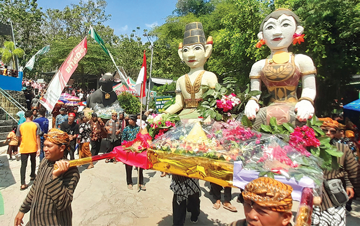 MERIAH: Patung Loro Blonyo ikut dirampilkan dalam kirab sedekah bumi di sendang Desa Plesungan, Kecamatan Gondangrejo, Minggu (6/8) siang.