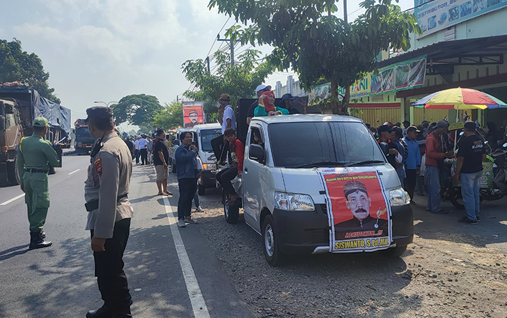 DIKAWAL APARAT: Arak-arakan calon kepala desa dalam Pilkades Jetak, Kecamatan Sidoharjo, kemarin (4/10).