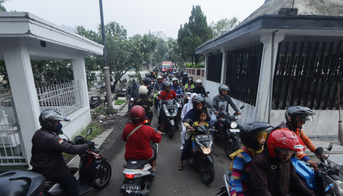 Jalan inspeksi di tengah makam atau TPU Bonoloyo yang padat kendaraan, Rabu (28/2).