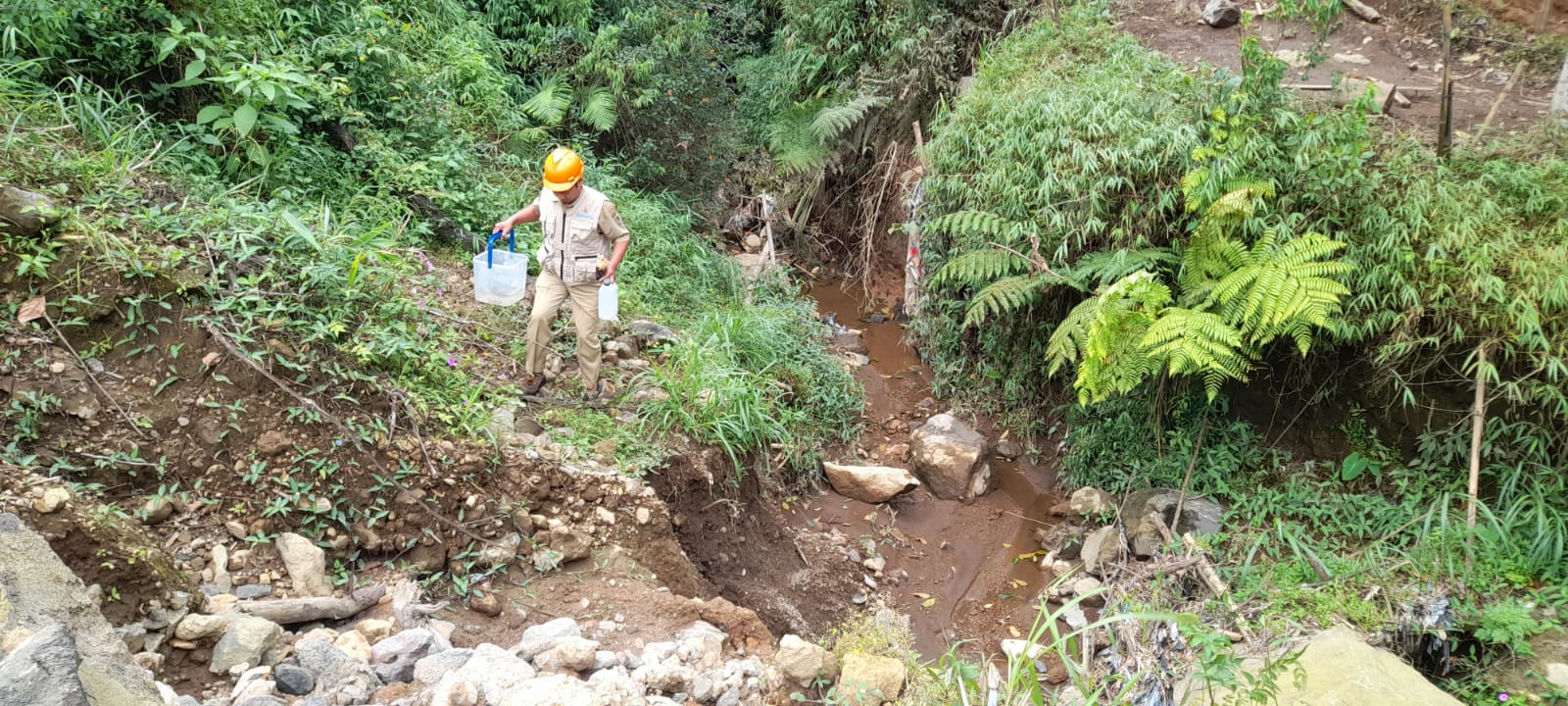Petugas DLH Kabupaten Karanganyar mengambil sampel air dari kebun teh Kemuning. (Rudi Hartono/Radar Solo)