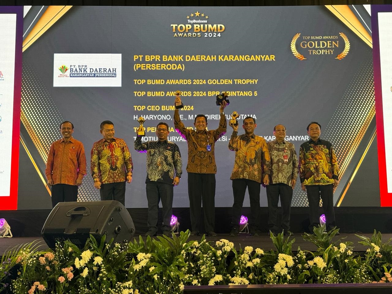 Dirut PT BPR Bank Daerah Karanganyar Haryono (tengah) tunjukkan penghargaan. (Dok.Pribadi)