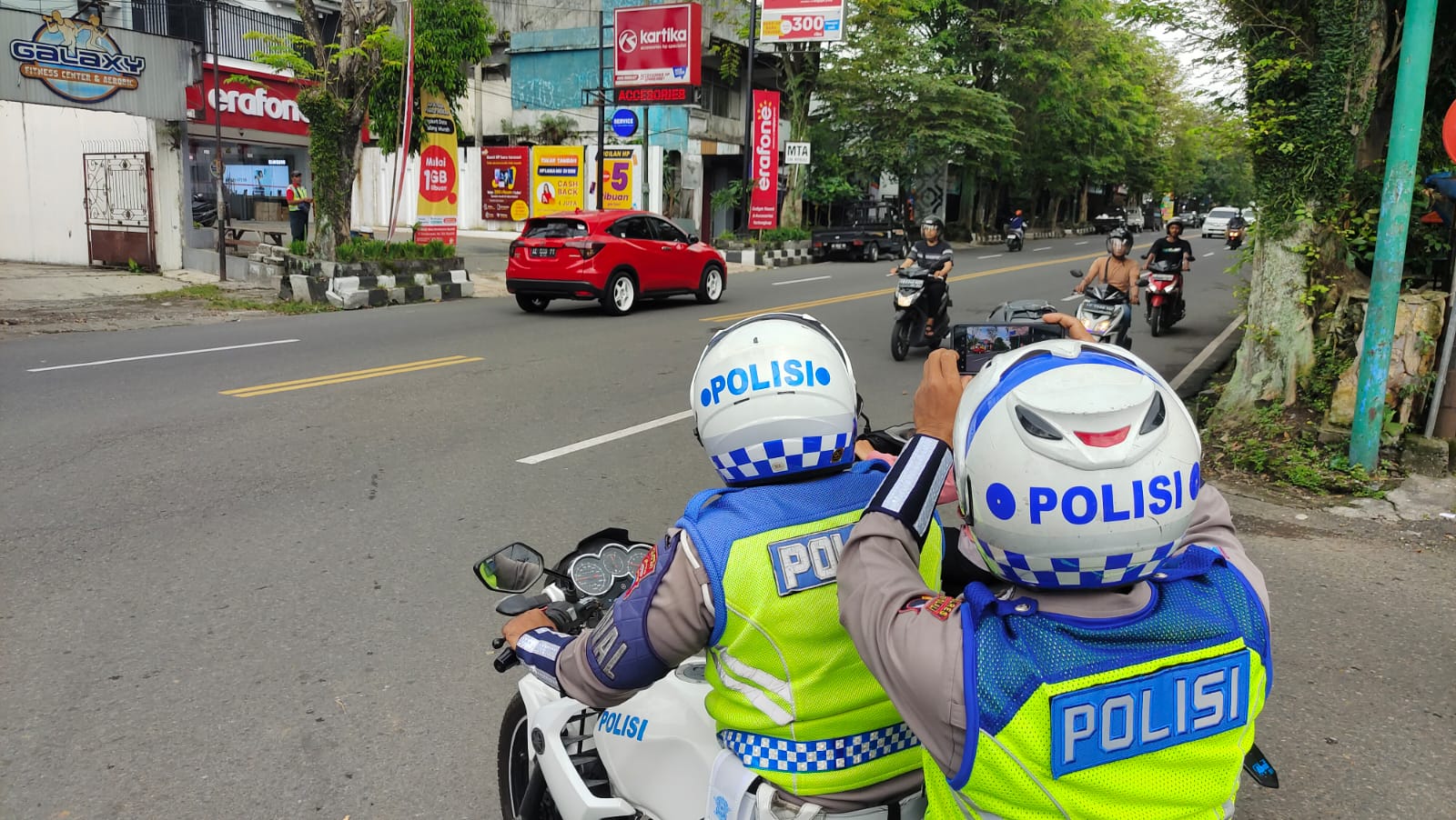 Anggota Satlantas Polres Boyolali merekam pelanggaran lalu lintas menggunakan smartphone.