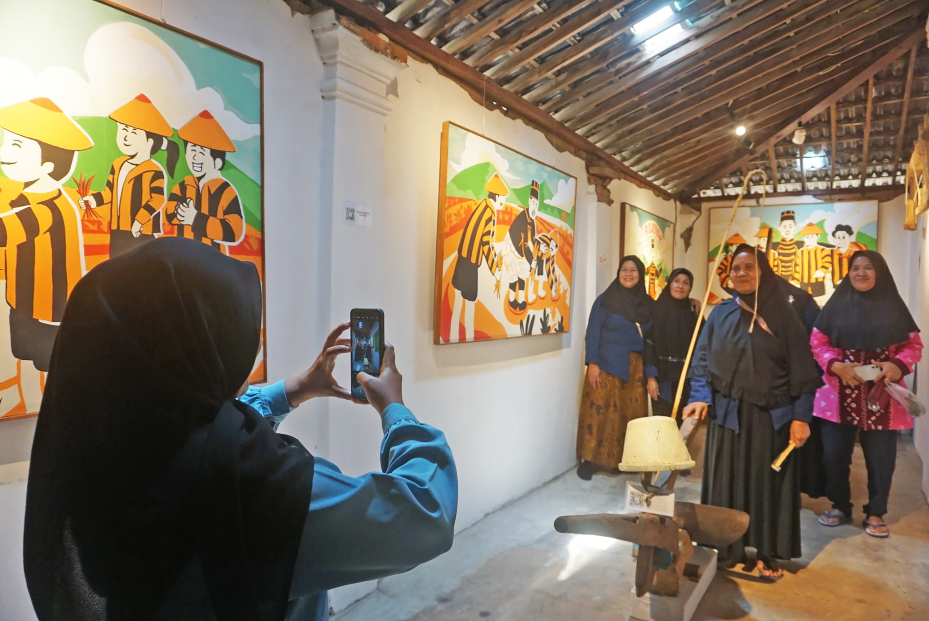 Wistawan berfoto di antara alat pertanian jadul di Museum Omah Rojolele, Delanggu, Klaten. (Angga Purenda/Radar Solo)