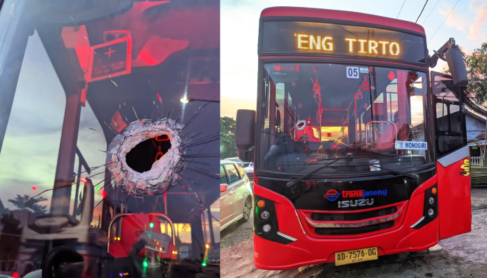Bus Trans Jateng Koridor VII Solo-Wonogiri dan kondisi kaca depan yang berlubang setelah dilempar batu orang tak dikenal.