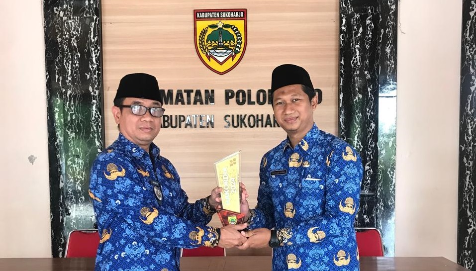 Camat Polokarto Herry Mulyadi (kiri) dan Kades Wonorejo  Yusuf Aziz Rahma pamerkan trofi Desa Antikorupsi belum lama ini.