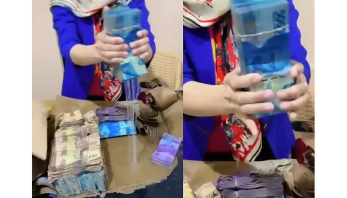 Tangkapan layar video viral gepokan uang diperas lantaran basah kuyup terendam air banjir.