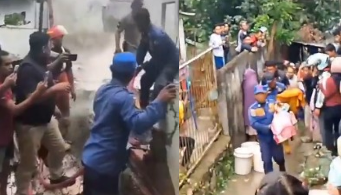 Petugas saat proses evakuasi balita yang jadi korban kebakaran di Kendari. Dalam insiden itu, tiga balita meninggal saat ditinggal sang ibu beli makan bareng pacar.