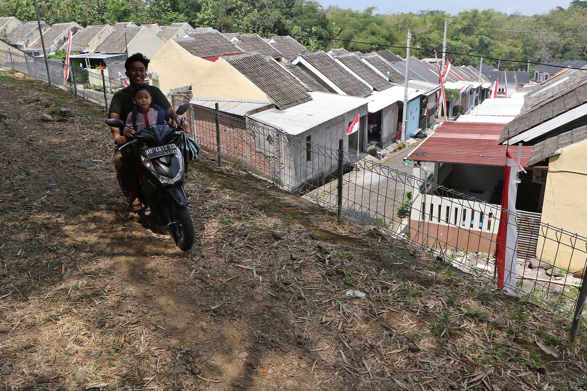 Warga mengantar anaknya sekolah, melintasi deretan perumahan subsidi di Kecamatan Ngemplak, Kabupaten Boyolali, Kamis (21/8).