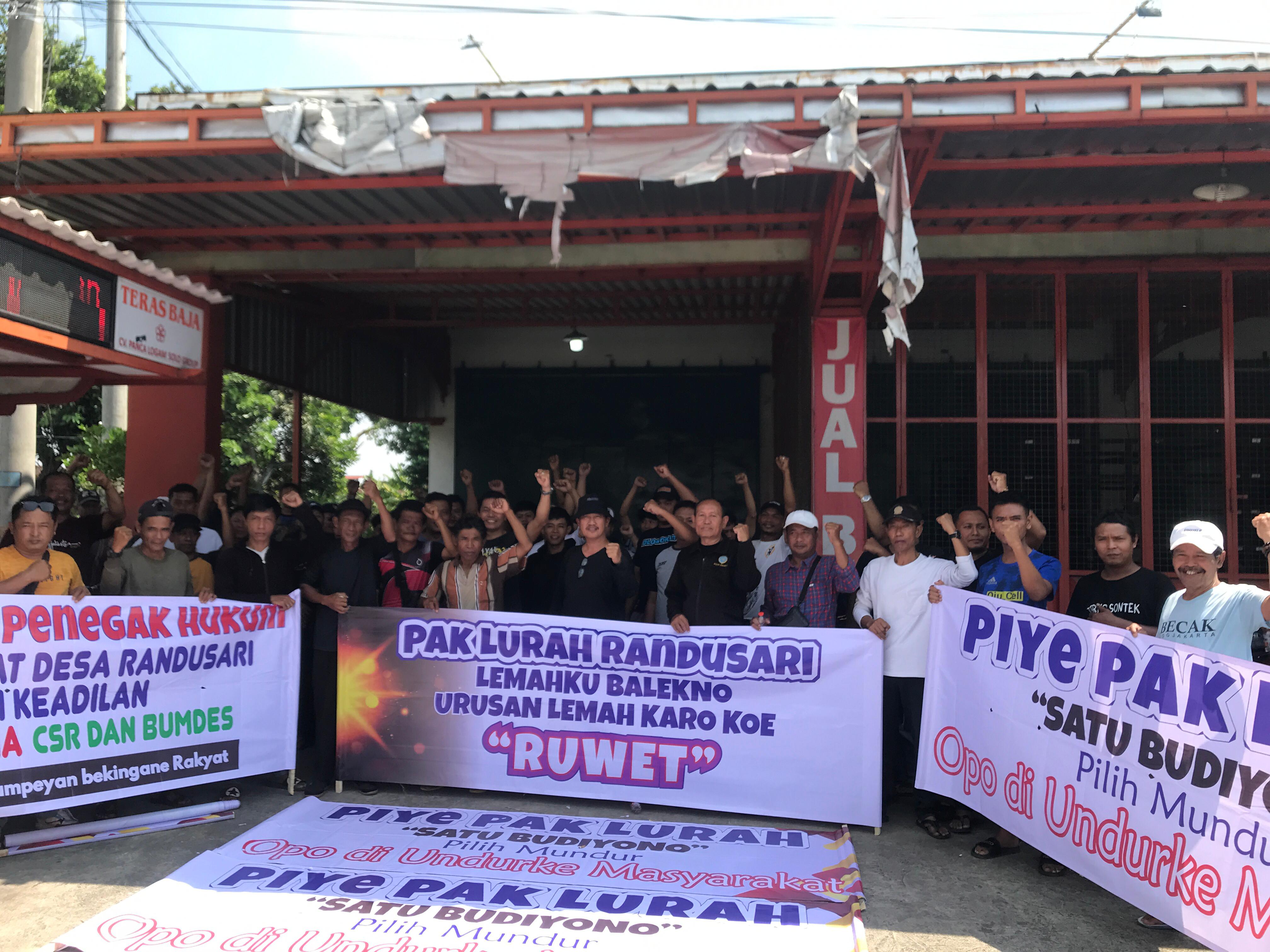 Warga Desa Randusari, Kecamatan Teras, Boyolali bentangkan spanduk yang memprotes kades setempat karena agunkan tanah kas desa untuk dapat pinjaman bank.