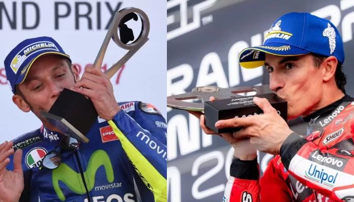 Momen Valentino Rossi dan Marc Marquez mencium trofi kemenangan MotoGP.