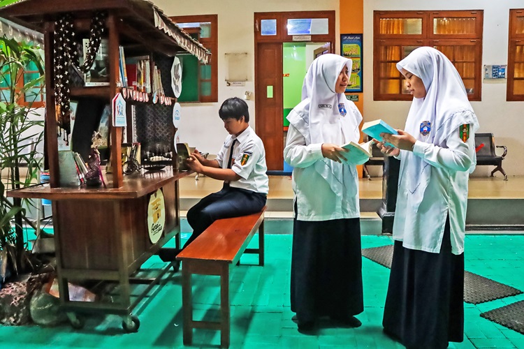 Siswa SMP Muhammadiyah PK Kottabarat Surakarta membaca buku di angringan literasi.