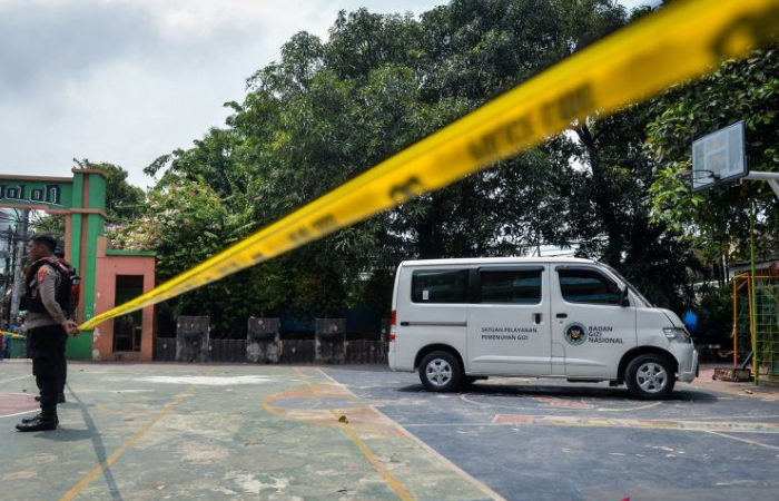 Polisi berjaga di dekat mobil pengangkut Makan Bergizi Gratis (MBG) yang menabrak siswa dan guru di SDN Kalibaru 01 Pagi, Cilincing, Jakarta, Kamis (11/12/2025).
