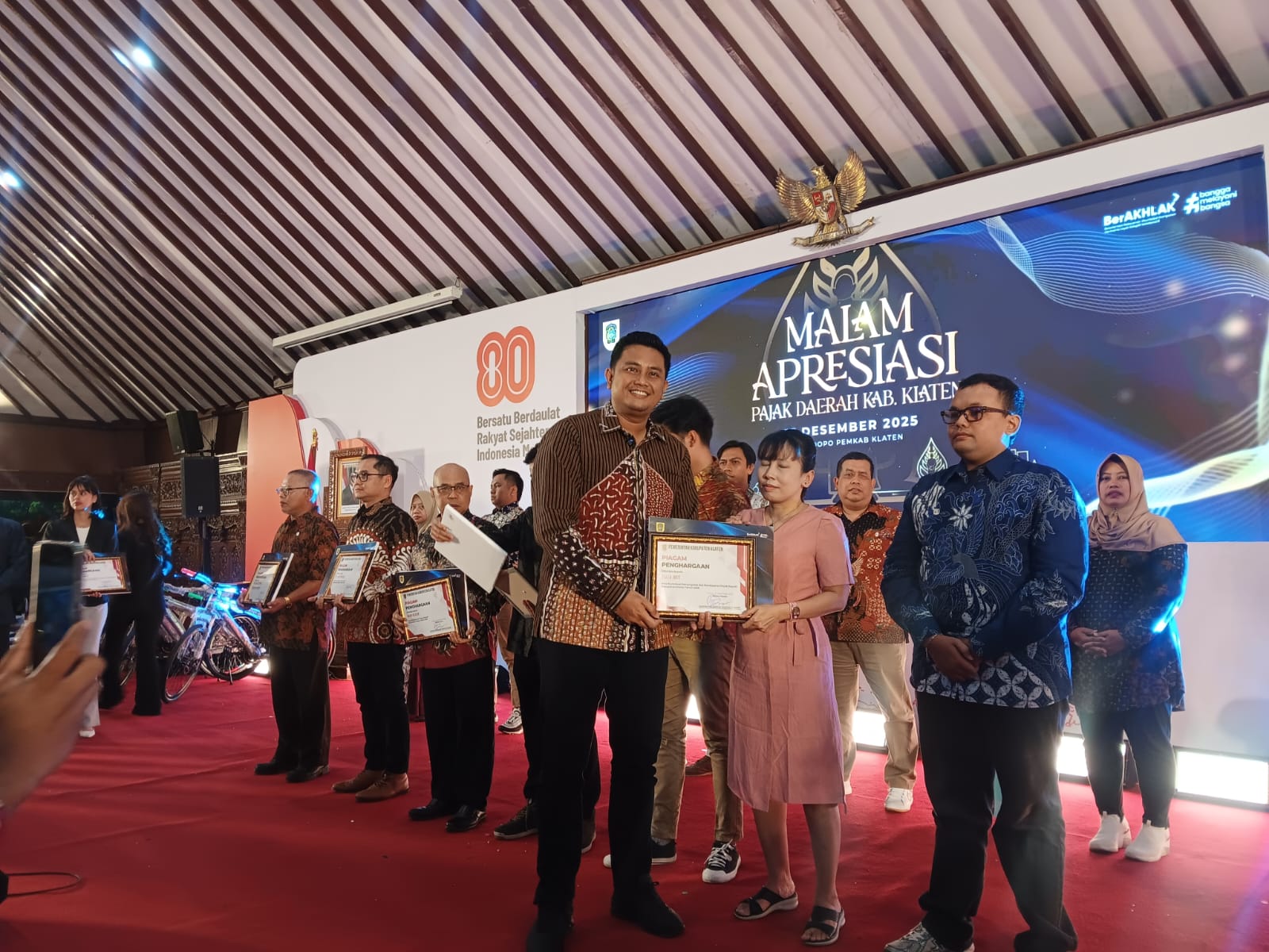 Bupati Klaten Hamenang Wajar Ismoyo saat menyerahkan penghargaan kepada wajib pajak di Malam Apresiasi Pajak Daerah 2025 di Pendapa Pemkab Klaten