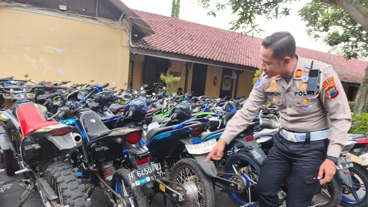 Kasatlantas Polres Sragen AKP Kukuh Tirto Satriyo Utomo tunjukkan sepeda motor berknalpot brong yang disita di mapolres, Senin (22/6/2026). (Ahmad Khairudin/Radar Solo)